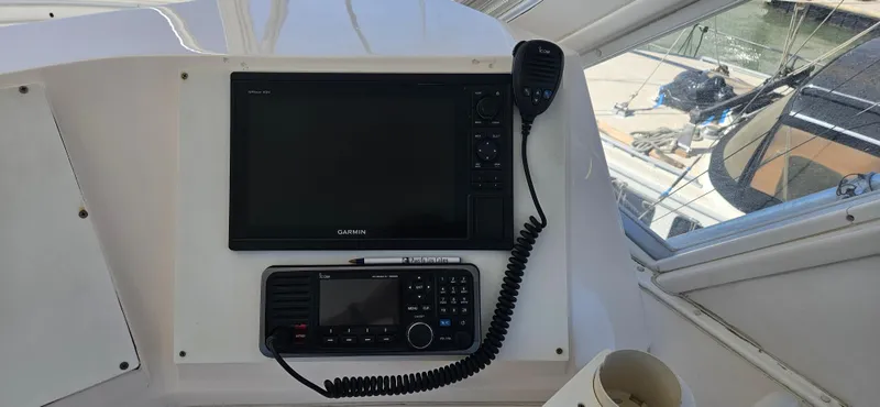 Slide: The Image of 1995 Bertram Convertible boat dashboard with navigation and communication equipment. - 21