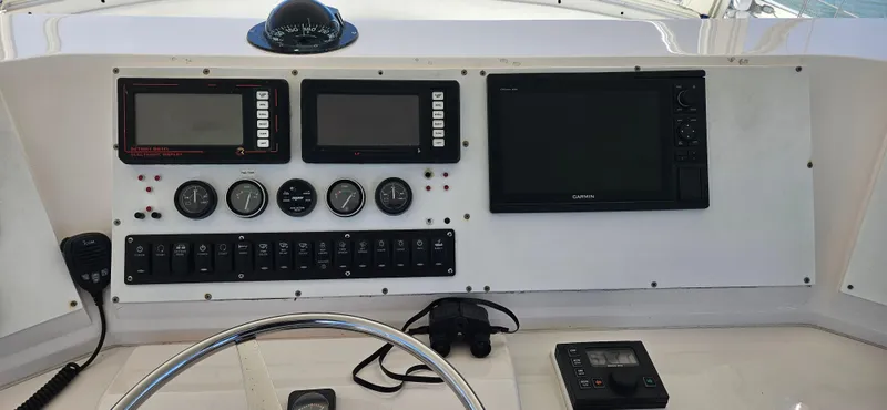Slide: The Image of Control panel of a 1995 Bertram Convertible boat with navigation instruments and gauges. - 22