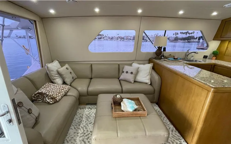 Slide: The Image of Luxurious interior of a 1995 Bertram Convertible yacht with plush seating and elegant decor. - 30