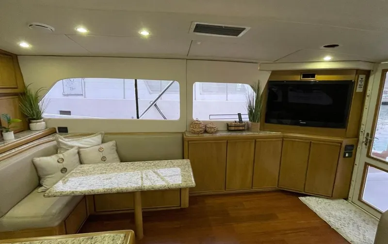 Slide: The Image of Interior of a 1995 Bertram Convertible yacht with cozy seating and modern amenities. - 31