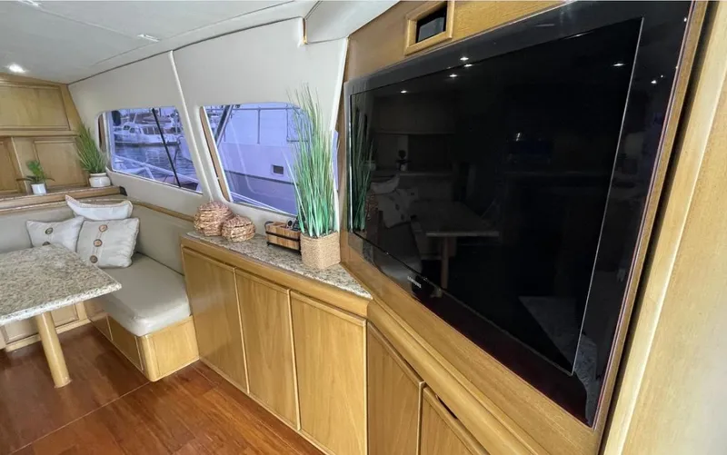Slide: The Image of Interior of a 1995 Bertram Convertible yacht with modern decor and large TV. - 32