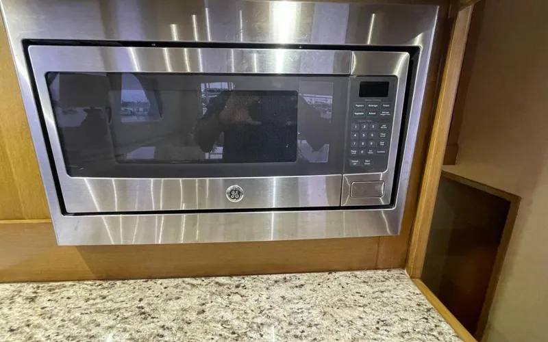 Slide: The Image of Built-in microwave in a 1995 Bertram Convertible yacht kitchen. - 35
