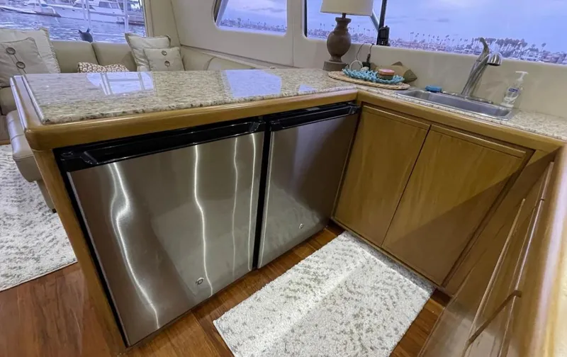 Slide: The Image of Interior of a 1995 Bertram Convertible yacht with modern kitchen amenities. - 36