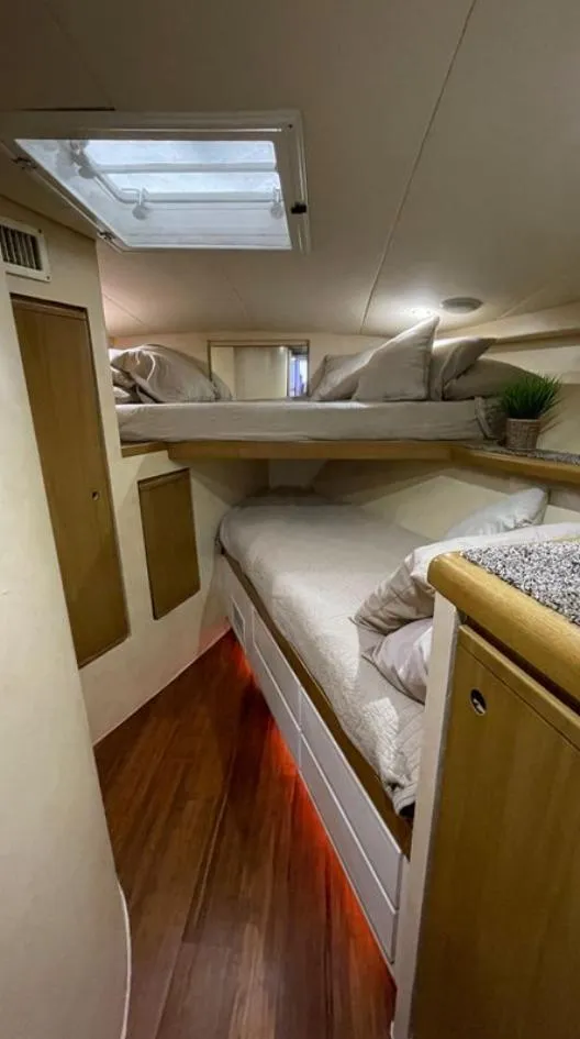 Slide: The Image of Interior of a 1995 Bertram Convertible yacht with cozy sleeping quarters. - 39