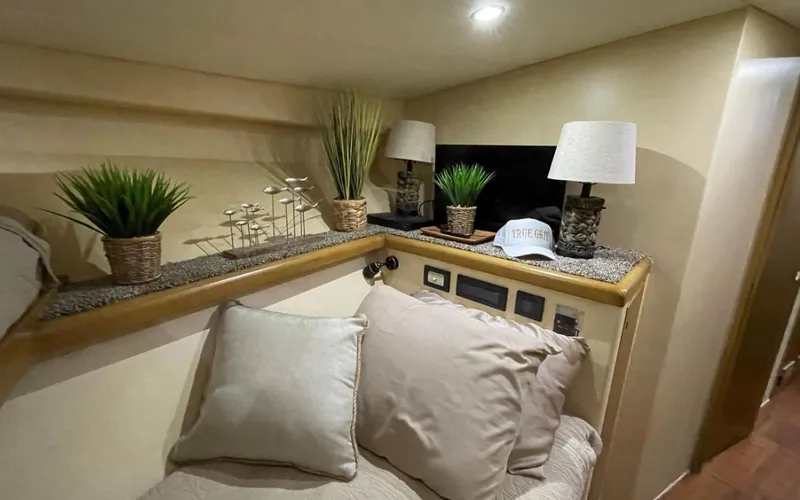 Slide: The Image of Cozy cabin interior of a 1995 Bertram Convertible with plants and lamps on a shelf. - 40