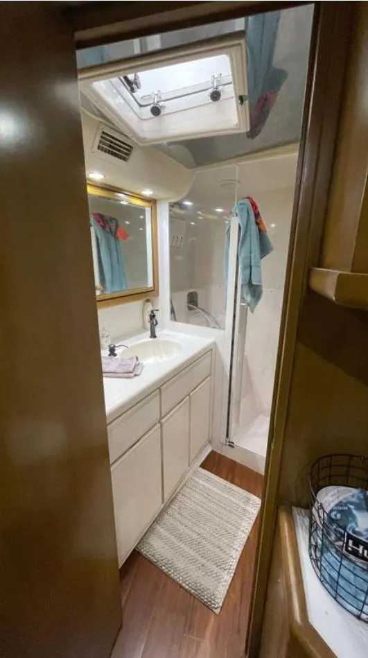 Slide: The Image of Bathroom interior of a 1995 Bertram Convertible yacht with shower and vanity. - 47