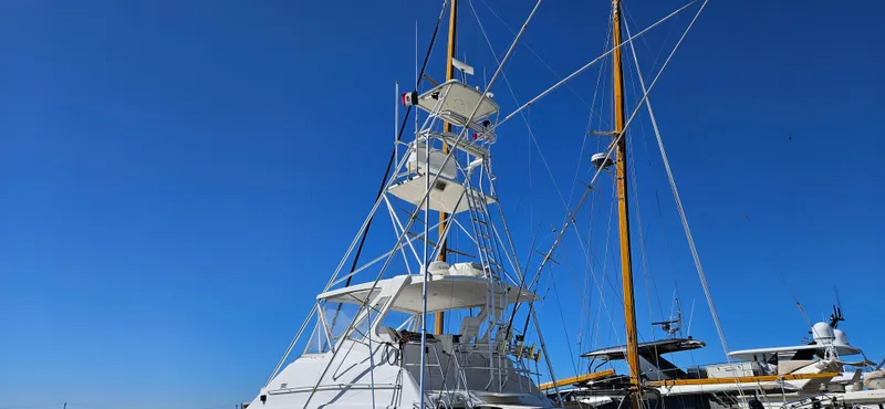 Slide: The Image of 1995 Bertram Convertible yacht with tall tower against clear blue sky. - 5