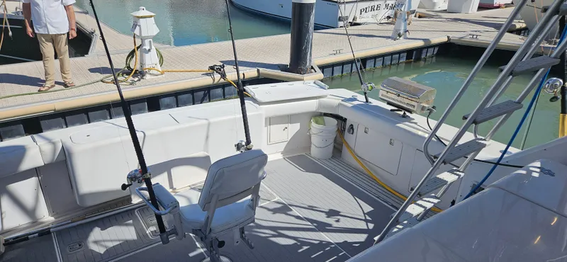 Slide: The Image of 1995 Bertram Convertible boat interior with fishing rods, docked at marina. - 7