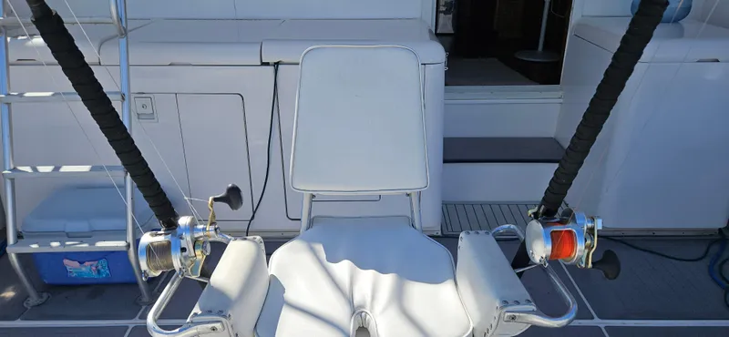 Slide: The Image of Fishing chair with rods on a 1995 Bertram Convertible boat deck. - 8