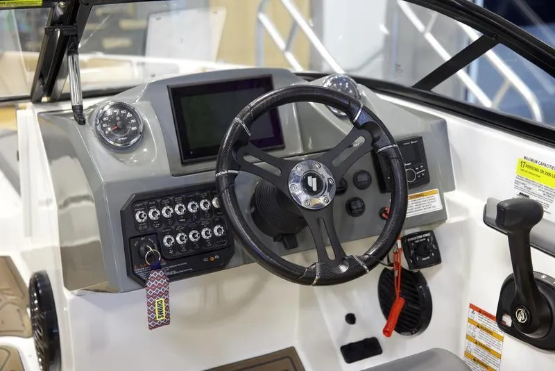 Slide: The Image of 2023 Heyday WTSurf boat dashboard with steering wheel and control panel. - 13