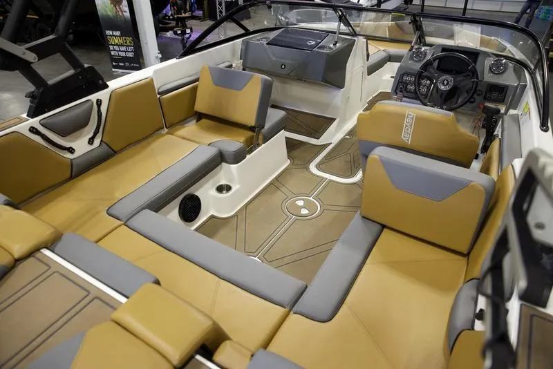 Slide: The Image of 2023 Heyday WTSurf boat interior with tan and gray seating, modern dashboard, and spacious layout. - 14