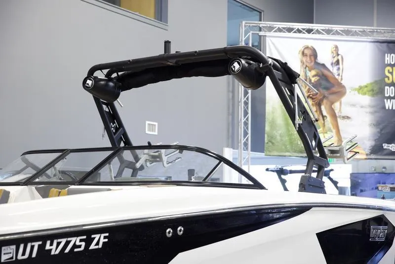 Slide: The Image of 2023 Heyday WTSurf boat with sleek design and modern features in showroom setting. - 7