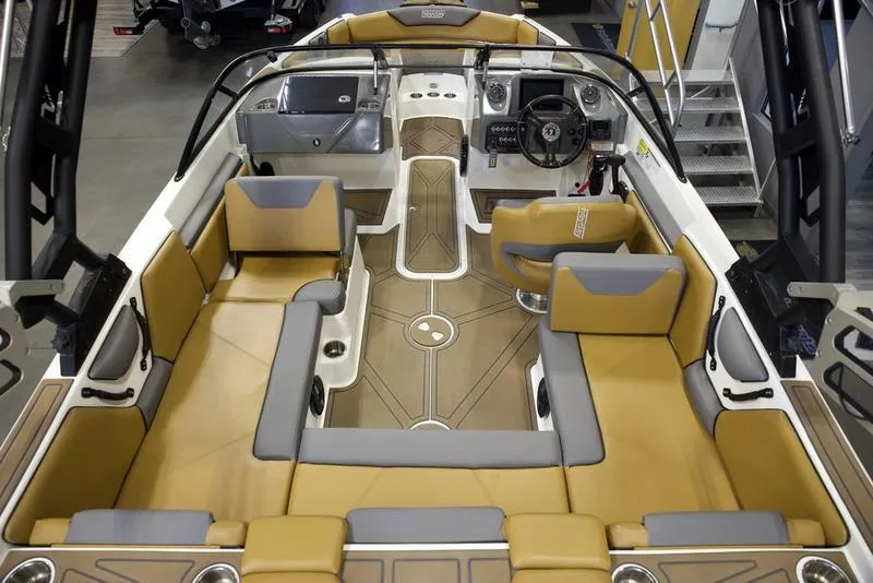 Slide: The Image of 2023 Heyday WTSurf boat interior with tan and gray seating, modern dashboard, and spacious layout. - 9