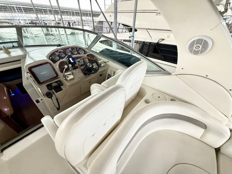 Slide: The Image of 2004 Sea Ray 340 Sundancer cockpit with white seating and control panel. - 11