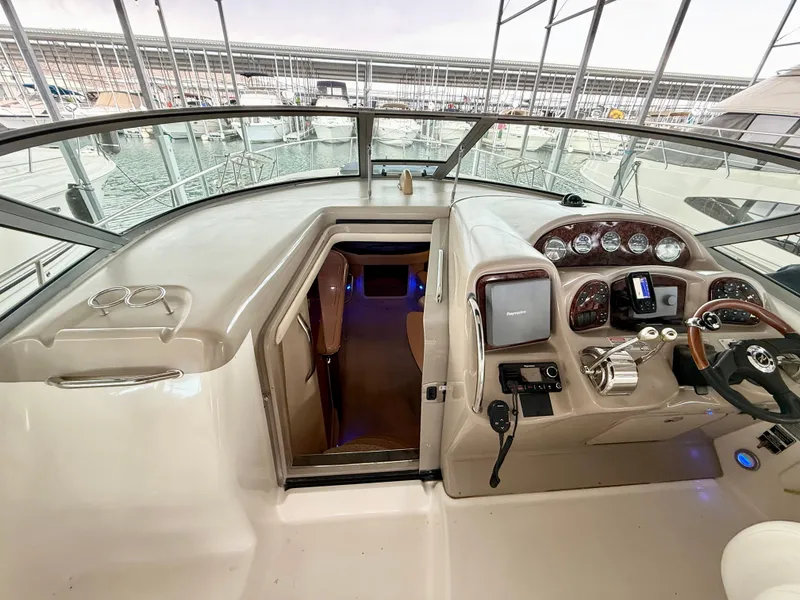 Slide: The Image of 2004 Sea Ray 340 Sundancer helm with modern controls and cabin entrance. - 12
