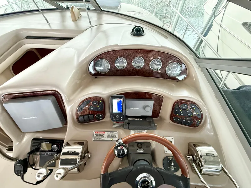 Slide: The Image of 2004 Sea Ray 340 Sundancer helm with gauges, navigation equipment, and steering wheel. - 13