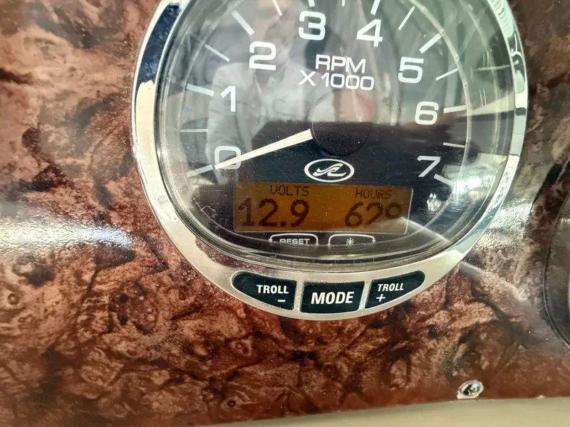 Slide: The Image of Close-up of 2004 Sea Ray 340 Sundancer RPM gauge displaying 12.9 volts and 62 hours. - 14