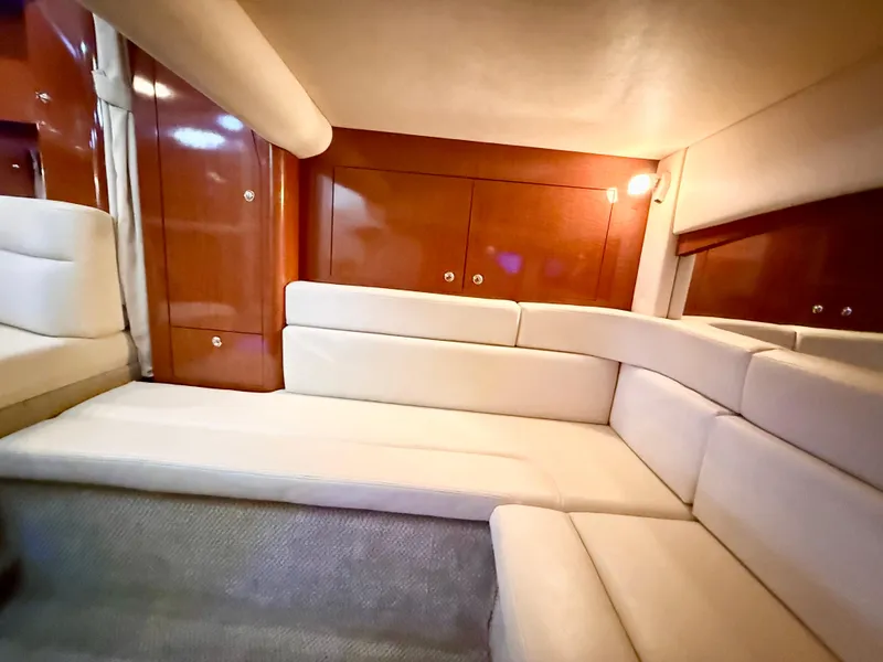 Slide: The Image of Interior of 2004 Sea Ray 340 Sundancer with beige seating and wooden cabinetry. - 20