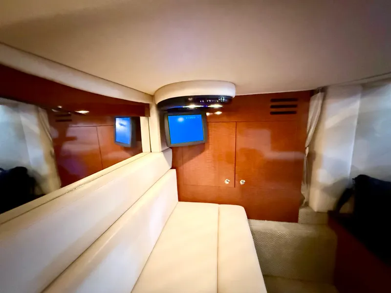 Slide: The Image of Interior of 2004 Sea Ray 340 Sundancer yacht with seating and TV. - 21