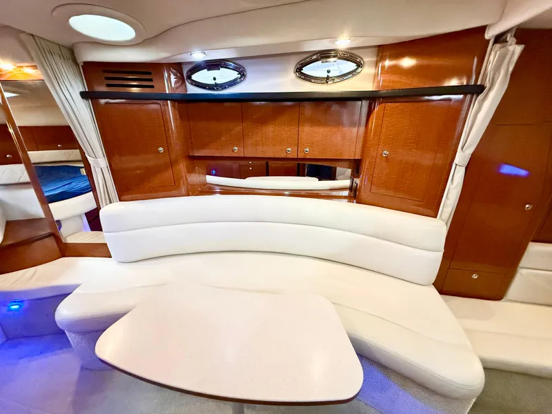 Slide: The Image of Luxurious interior of 2004 Sea Ray 340 Sundancer with elegant seating and wooden cabinetry. - 24