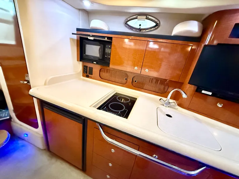 Slide: The Image of Luxurious 2004 Sea Ray 340 Sundancer yacht kitchen with modern amenities and sleek cabinetry. - 26