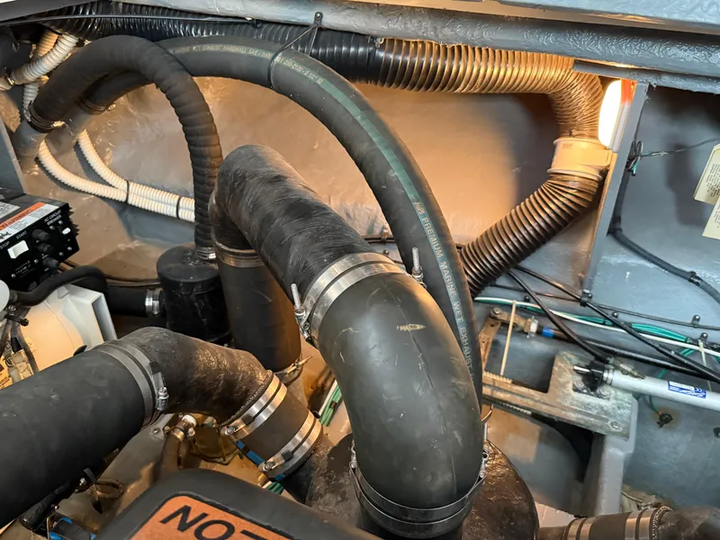 Slide: The Image of Engine compartment of 2004 Sea Ray 340 Sundancer with visible hoses and wiring. - 32