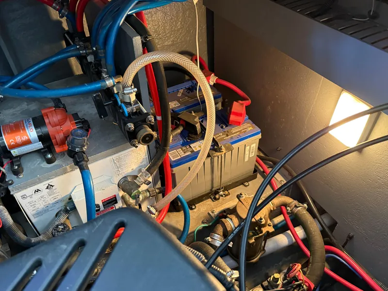 Slide: The Image of Engine compartment of a 2004 Sea Ray 340 Sundancer with visible wiring and components. - 35