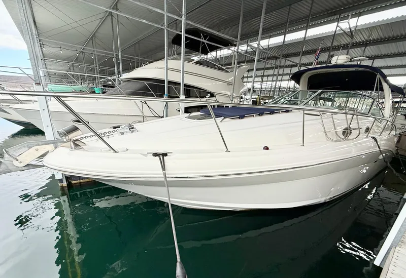 Slide: The Image of 2004 Sea Ray 340 Sundancer docked in a marina under a covered shelter. - 5