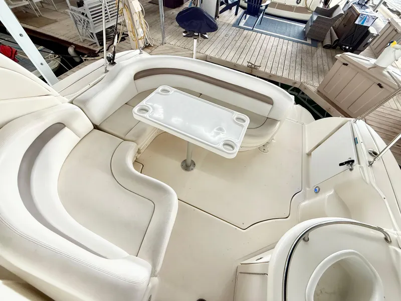 Slide: The Image of 2004 Sea Ray 340 Sundancer boat interior with seating and table. - 9