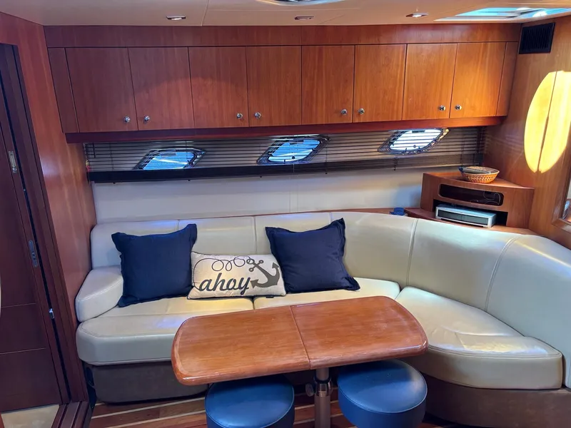 Slide: The Image of Interior of 2010 Regal 44 Sport Coupe with cozy seating and nautical decor. - 38