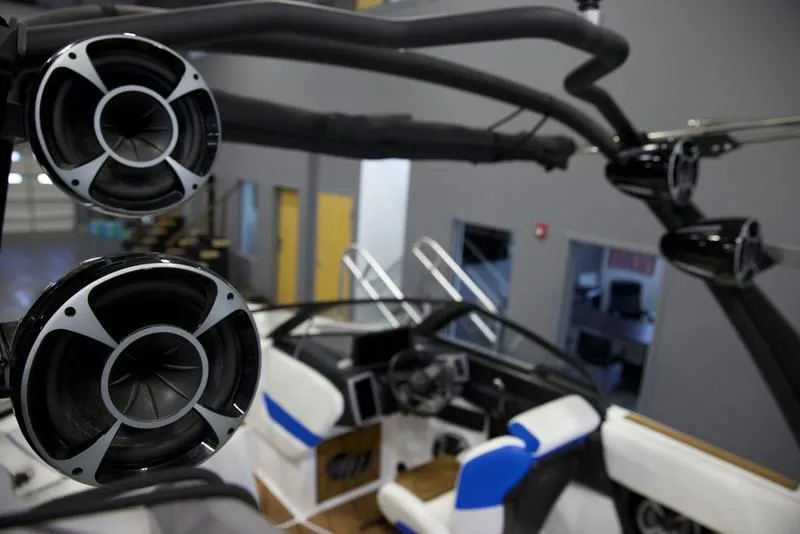 Slide: The Image of 2024 Malibu 23 LSV boat interior with speakers and seating. - 12