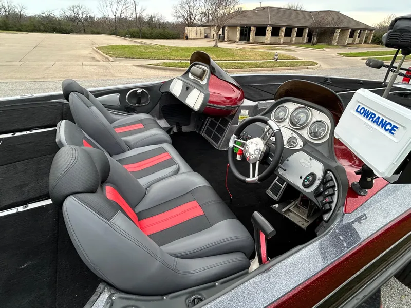 Slide: The Image of 2008 Ranger Z21 boat interior with gray and red seats, steering wheel, and Lowrance equipment. - 19