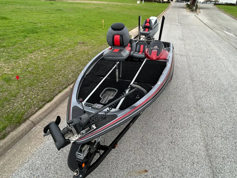 Slide: The Image of 2008 Ranger Z21 fishing boat on road, featuring red and black seating. - 21