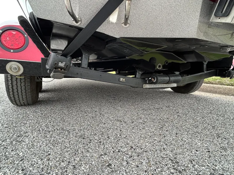 Slide: The Image of 2008 Ranger Z21 boat trailer hitch and wheel on asphalt road. - 25