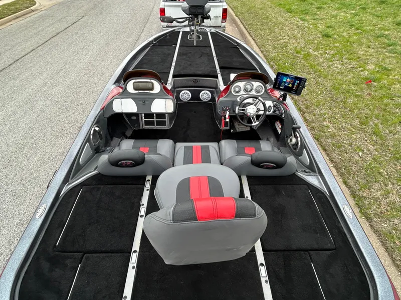 Slide: The Image of 2008 Ranger Z21 boat interior with modern dashboard and seating, parked on a street. - 31