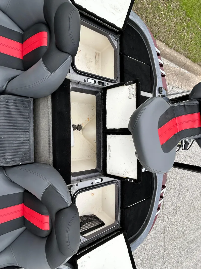 Slide: The Image of 2008 Ranger Z21 boat interior with open storage compartments and black-red seats. - 41