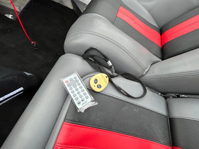 Slide: The Image of 2008 Ranger Z21 interior with remote and lanyard on red and gray seat. - 42