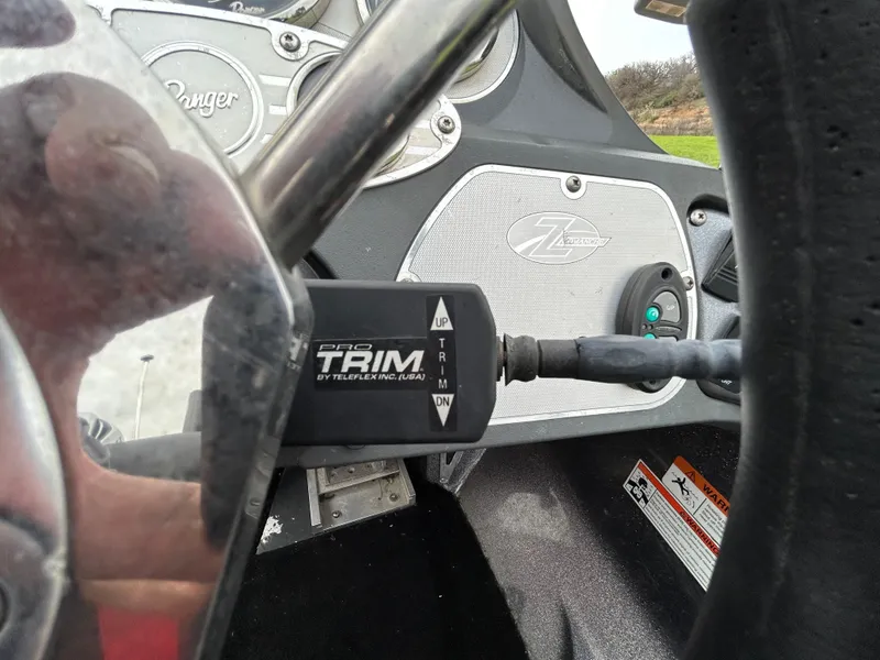 Slide: The Image of 2008 Ranger Z21 boat dashboard with trim control and steering wheel. - 43