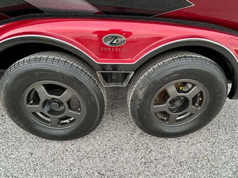 Slide: The Image of 2008 Ranger Z21 trailer with dual wheels and red fender on asphalt. - 47