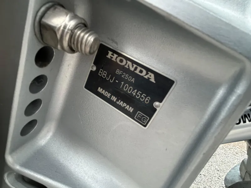 Slide: The Image of Honda BF250A engine plate, serial number BBJJ-1004556, made in Japan. - 52