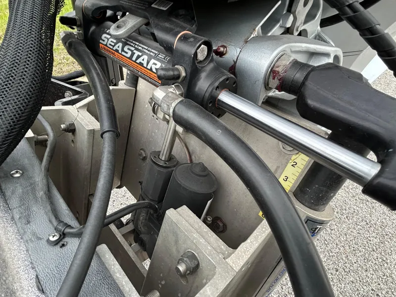 Slide: The Image of Close-up of a 2008 Ranger Z21 boat's SeaStar hydraulic steering system. - 53