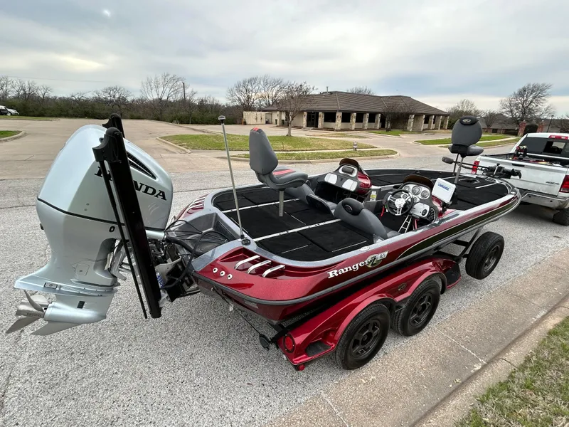 Slide: The Image of 2008 Ranger Z21 boat on trailer by a lake under clear blue sky. - 6