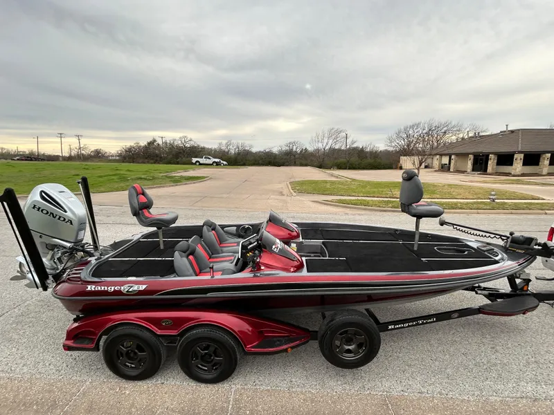 Slide: The Image of 2008 Ranger Z21 boat with Honda motor on trailer, parked outdoors. - 65