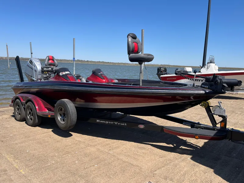 Slide: The Image of 2008 Ranger Z21 boat with Honda outboard motor parked on a street. - 9