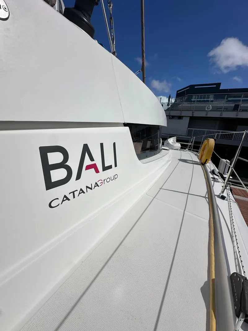 Slide: The Image of 2023 Bali 4.2 catamaran by Catana Group docked under a clear blue sky. - 20