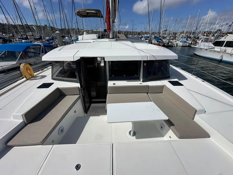 Slide: The Image of 2023 Bali 4.2 yacht with spacious deck seating and table in marina. - 30