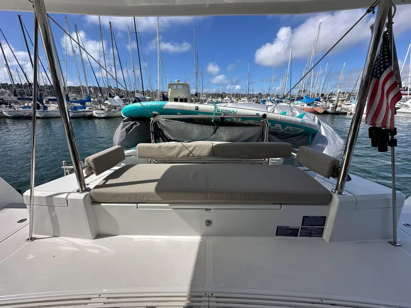 Slide: The Image of 2023 Bali 4.2 yacht with American flag, docked in marina under blue sky. - 36