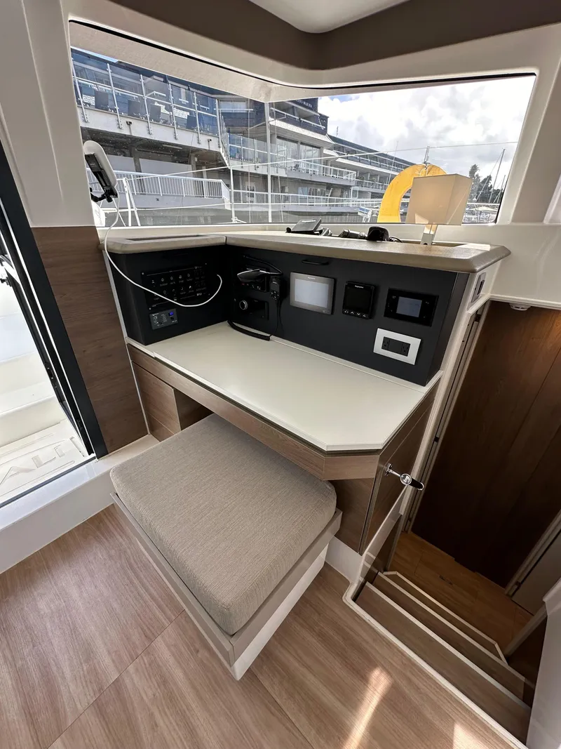 Slide: The Image of 2023 Bali 4.2 yacht interior helm station with navigation controls and seating. - 45