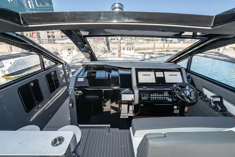 Slide: The Image of 2023 Cruisers Yachts 42 GLS helm with modern navigation systems and luxurious interior. - 26