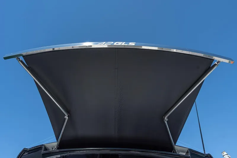 Slide: The Image of 2023 Cruisers Yachts 42 GLS canopy against clear blue sky. - 7